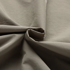 Macro view showing the durable khaki functional fabric texture of the casual outdoor vest