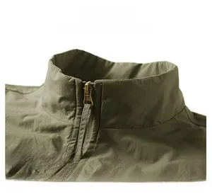 Detail of army green stand collar vest with metallic zipper and reinforced stitching