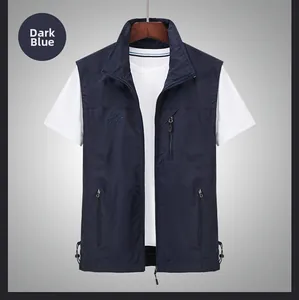 Detail of dark blue outdoor vest featuring embroidery and functional zipper pockets