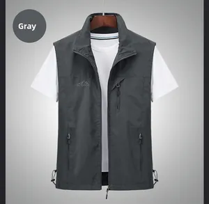 Close-up of gray outdoor utility vest with zipper pockets and embroidered outdoor logo