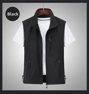 Detail of black outdoor vest showing zipper pockets and mountain embroidery on chest