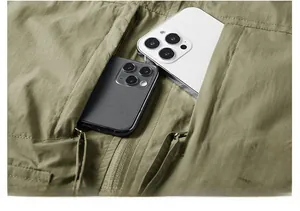 Detail of army green outdoor vest showing large zip pocket holding two smartphones