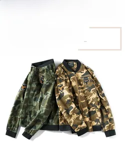 Detail of military bomber jackets in green and desert camouflage with embroidered patches