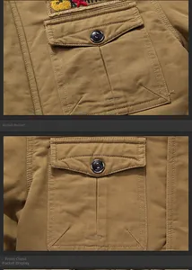 Detail view of khaki work jacket chest pockets with black buttons and embroidery