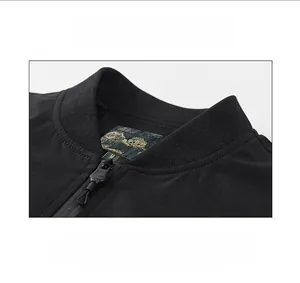 Detail of ribbed collar and mountain logo label on black zip-up bomber jacket