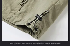 Detail of olive green vest hem featuring adjustable elastic drawstring and sturdy stitching
