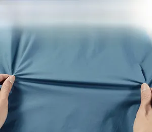 Detail showing high-elasticity blue fabric being stretched to demonstrate flexibility