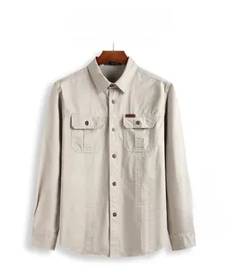 Detail of light khaki long-sleeved shirt with classic collar and dual chest pockets