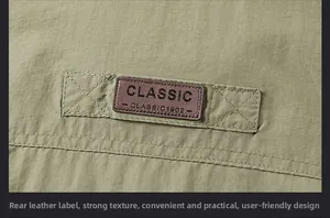 Detailed macro shot of olive green outdoor vest fabric with brown leather classic 1902 patch