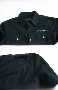 Detail of navy blue cotton work shirt showing collar and white OFF-ROAD lettering
