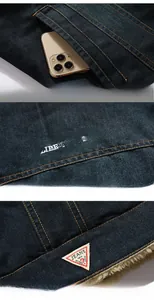 Detailed view of dark denim jacket with contrast stitching and fleece lining