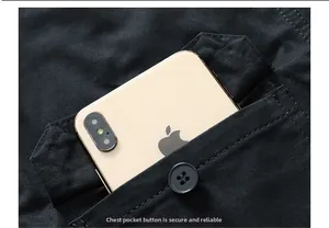 Close-up of black shirt chest pocket with button and large phone for size reference