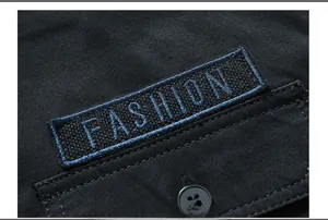 Detail of fashion embroidery and pocket on a men's black long sleeve casual shirt