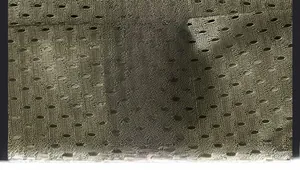 Detail of army green mesh fabric and care label showing 100% nylon material composition