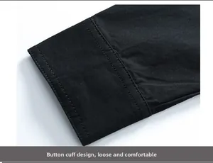 Detail shot of buttoned cuffs on a black cotton shirt with clean stitching and twill texture
