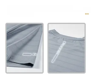 Detail view of breathable grey mesh fabric with fluorescent safety strips on sleeve and back