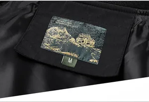 Detailed close-up of inner woven label and size tag on a black men's casual jacket