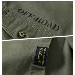 Macro view of military green cotton shirt featuring off-road prints and outdoor label details