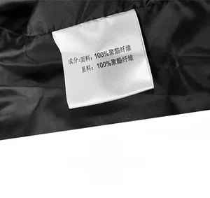 Detailed macro view showing the 100% polyester fabric care label on a black men's jacket
