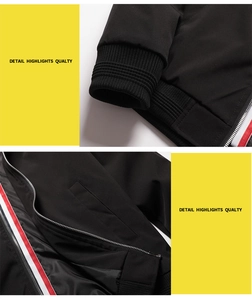 Detail of ribbed cuffs and red-white striped zipper trim on a men's black windbreaker
