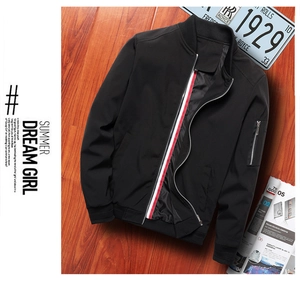 Detail of black bomber jacket featuring tricolor tape inside zipper and sleeve zip pocket