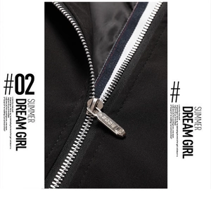 Close-up of black jacket metal zipper with tricolor red white blue ribbon detail