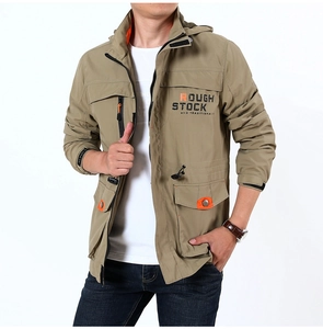 Detail of khaki outdoor jacket with orange snap buttons and ROUGH STOCK printed text