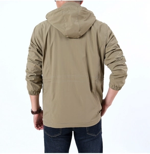 Detail view of the back of a men's khaki windbreaker with hood and elastic cuffs