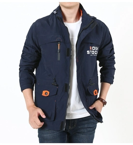 Detail of waterproof outdoor jacket with orange zipper accents and functional pockets