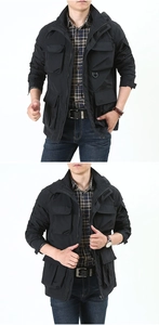 Detail of men's black hooded tactical jacket with functional cargo pockets and D-ring