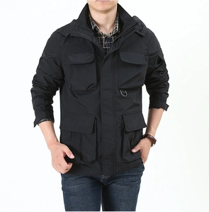 Close-up of black tactical jacket detailing multi-pocket cargo design and durable fabric