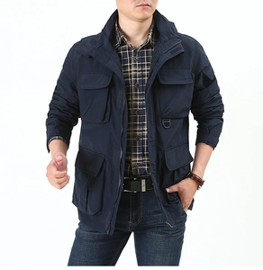 Detail of navy blue tactical jacket showing sleeve pocket with embossed letter logo