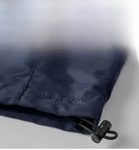 Detail of adjustable hem with elastic drawstring and stitching on navy blue outdoor jacket