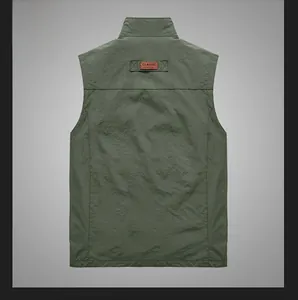 Close-up of olive green fishing vest back with classic leather logo and durable fabric