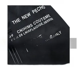 Detail of black shirt sleeve featuring white THE NEW PECHO typography print