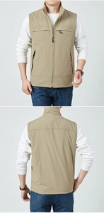 Detail view of khaki reversible fleece vest showing front and back zip pockets and stand collar