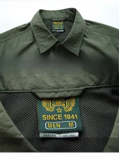 Detail of army green quick-dry shirt featuring breathable black mesh lining and collar