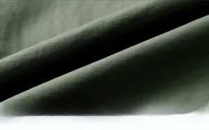 Detailed macro view of dark green water-resistant and soft outdoor functional fabric