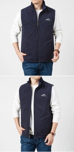 Detailed close-up of dark blue men's reversible fleece vest with outdoor chest print