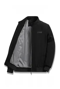 Detail of black corduroy jacket showing durable metal zipper and grey striped inner lining