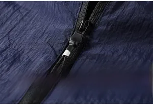 Detail of high-quality dark blue sun protection fabric with durable zipper and texture