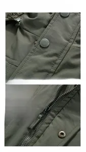 Detail of army green winter jacket featuring resin buttons and metal zipper with leather puller