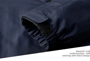 Macro view of adjustable Velcro cuff and precision stitching on navy outdoor jacket