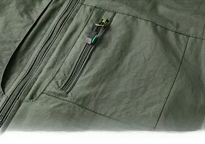 Close-up of military green outdoor vest featuring durable ripstop fabric and zipper pocket