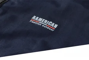 Detail of navy outdoor jacket featuring American Fashion logo and textured fabric