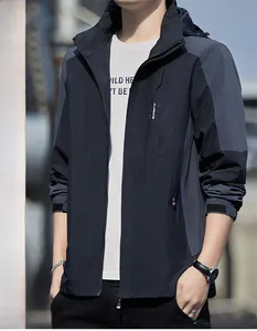 Detail of waterproof windbreaker showing navy blue and grey paneling with sport logo