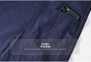 Macro shot showing the interior pocket of a navy ice silk jacket holding a smartphone
