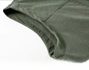 Detail view of durable olive green fabric texture and fine stitching on a men vest