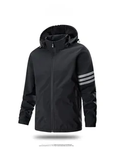 Close-up of three stripes on the sleeve of a black hooded windbreaker jacket