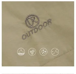 Detailed close-up of khaki outdoor jacket fabric featuring fine twill and DR OUTDOOR embroidery